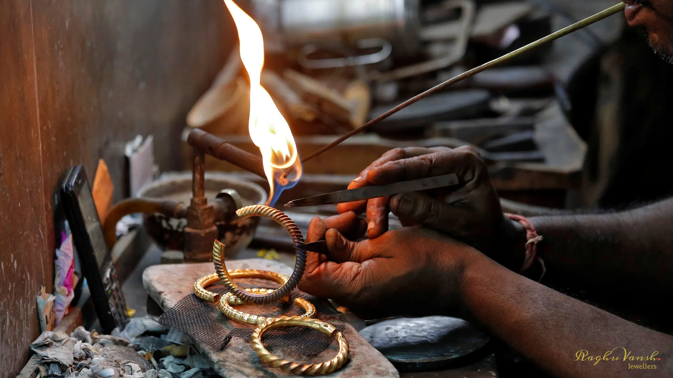 Goldsmith making lighweight traditional gold jewellery